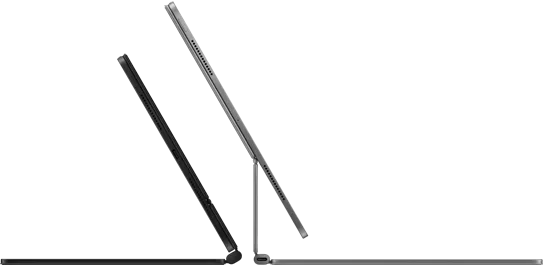 Two Magic Keyboards with iPad Pro attached shown back to back in Space Black and Silver finishes
