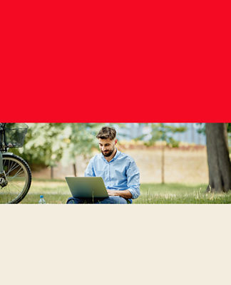 A man using his laptop in the park