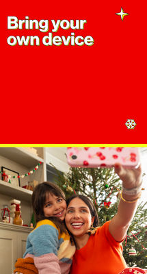 The image shows a mother and daughter taking a holiday selfie in front of their decorated tree.