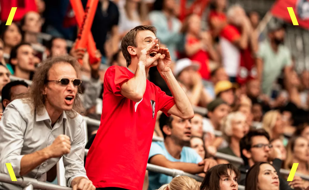 Fans cheering at a soccer match.