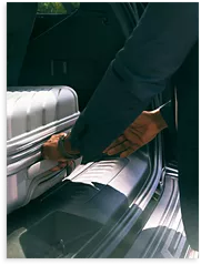 Man loading luggage into a car