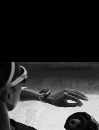 Jogger looking at Apple Watch Ultra 2 on left wrist, making double tap gesture with index finger and thumb of left hand