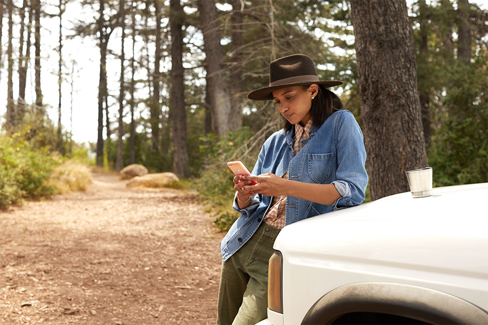 woman on phone in woods