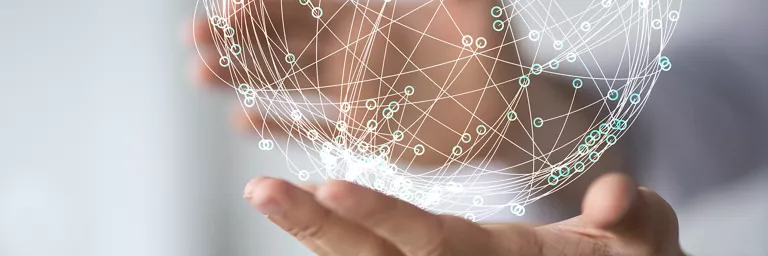 Hand holding a visual representation of data in a sphere like form