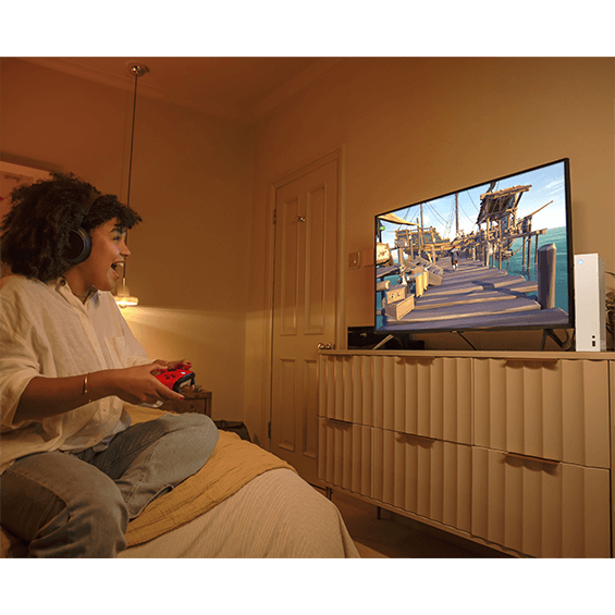 Lifestyle photo of girl playing the Xbox Series S Console