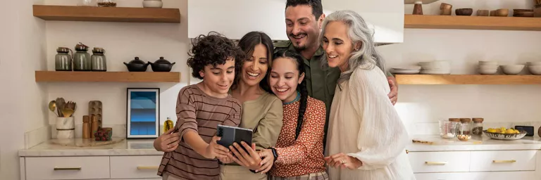 family standing around smartphone