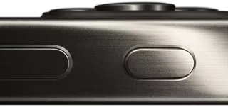 Side view of iPhone 15 Pro in a titanium design showing a volume button and Action button
