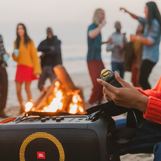 View of a JBL Party Box On-The-Go at a dance party.