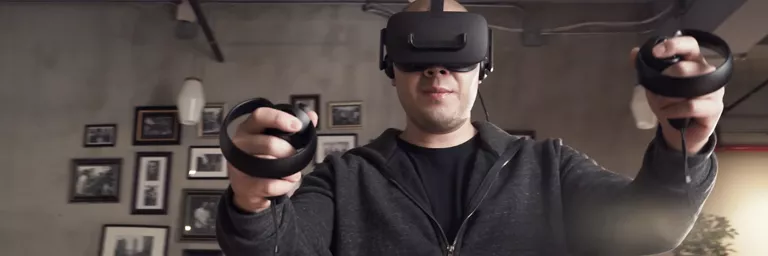 Man using a VR headset and controller to play games